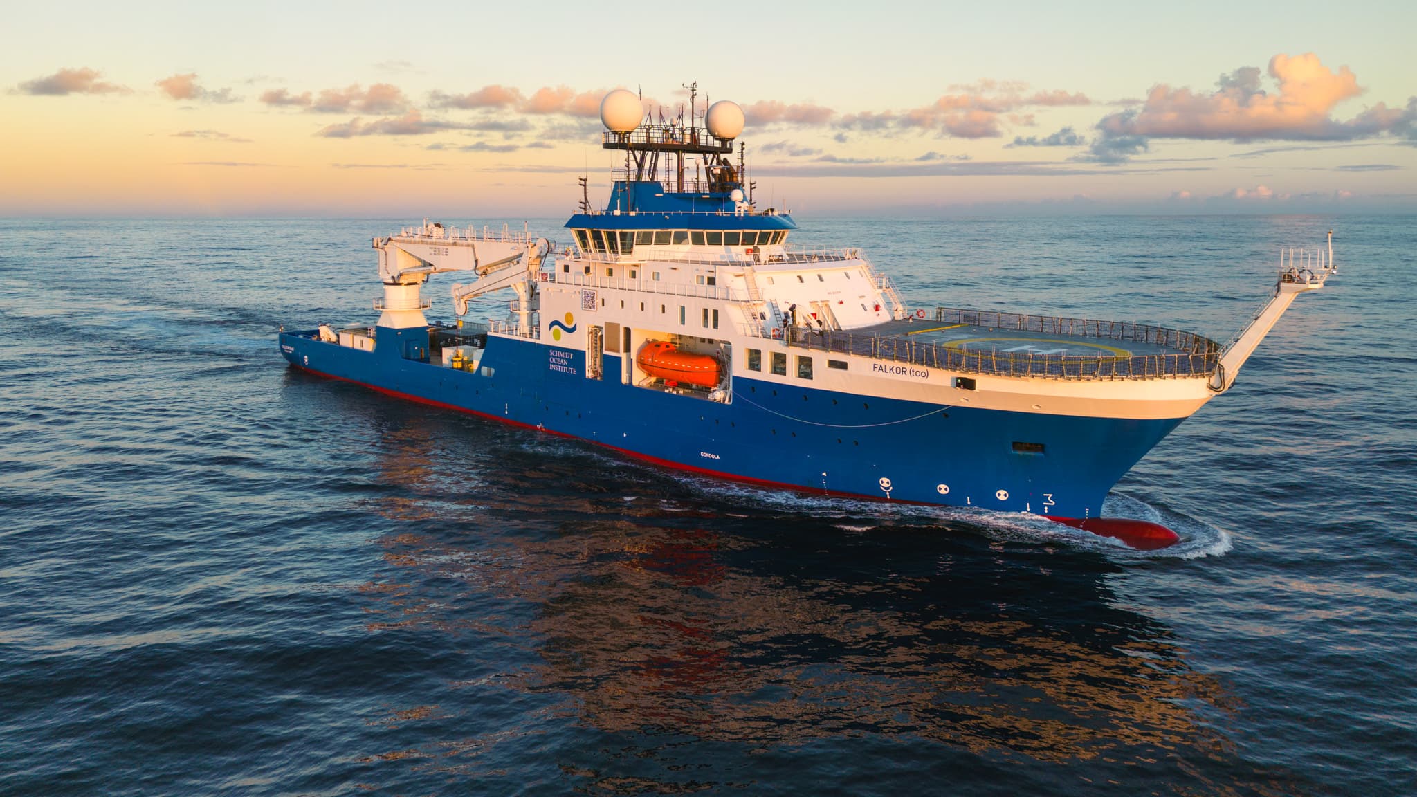 A large research ship moving across open water.