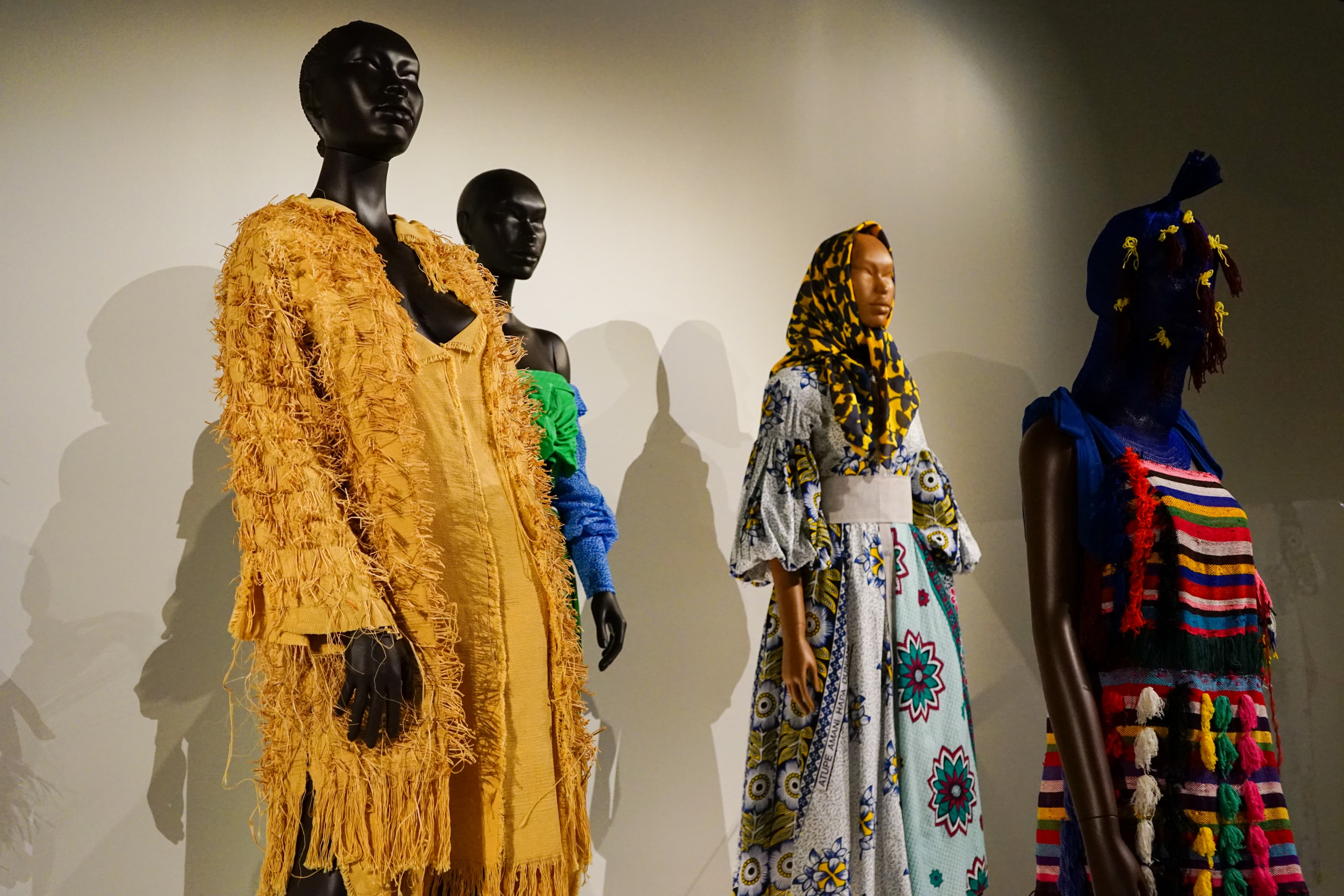 Several mannequins wearing colorful, patterened clothing.
