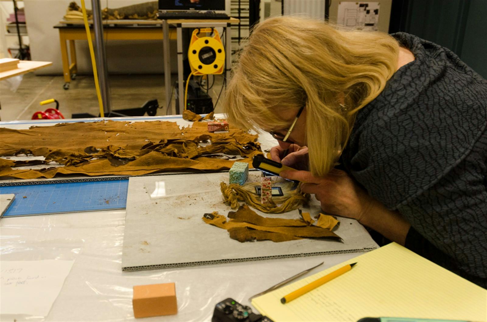Conservator Mimi Leveque examines and documents the condition of the shroud. Photo credit – JP Brown.