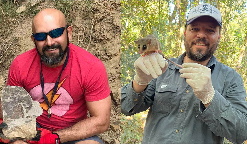 A man on the left, wearing a red shirt and sunglasses, holds a rock with a fossil plant; A man on the right, wearing a green button-down shirt and cap, holds a rodent with large eyes on his hand.